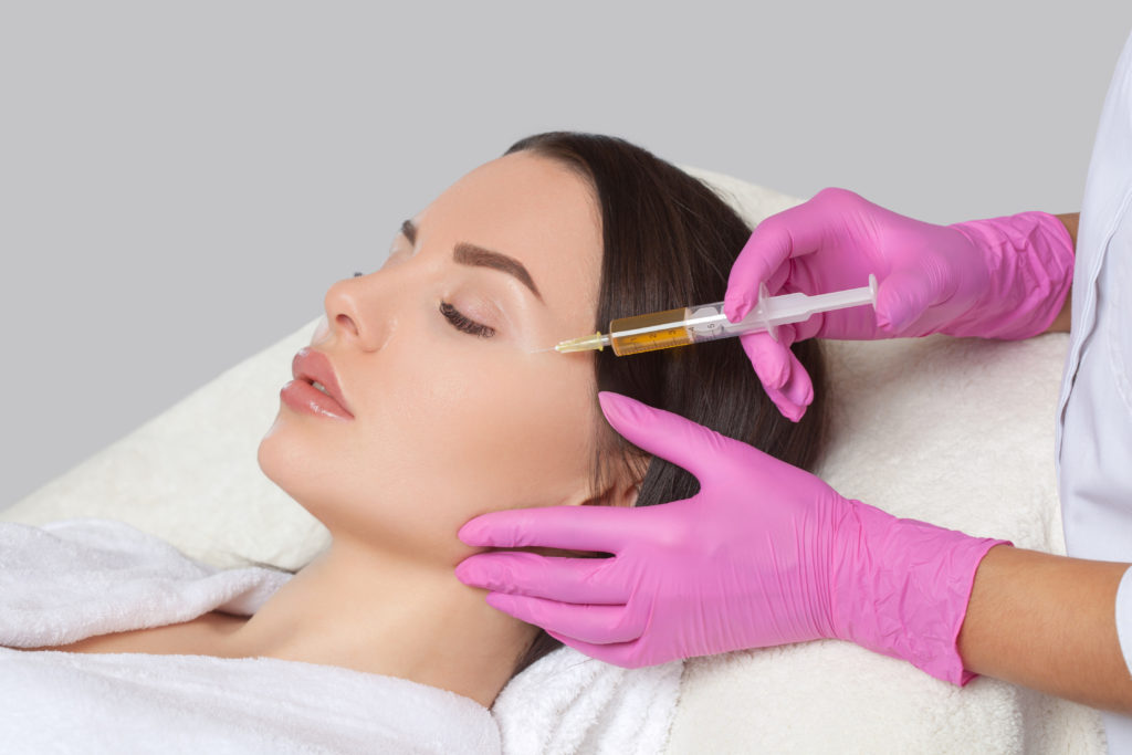 Lying Young female getting PRP PRF Treatment | Purely Natural Medical Spa in Brooklyn, NY