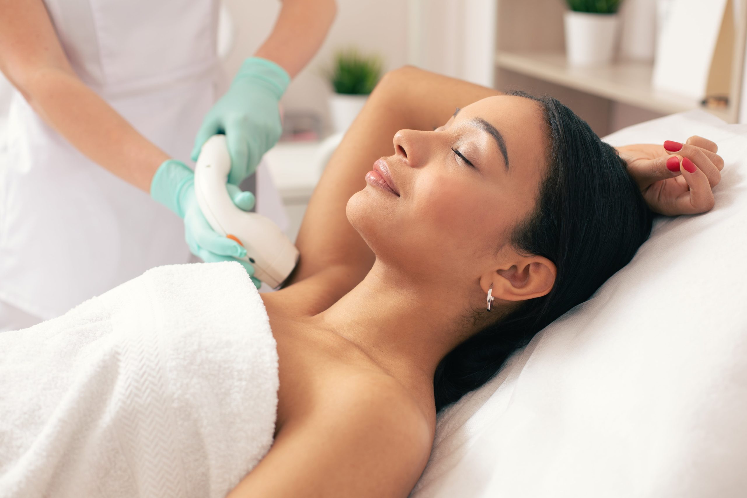 Closed Eye Laying Woman Having Laser Hair Removal Treatment | Purely Natural Medical Spa in Brooklyn, NY