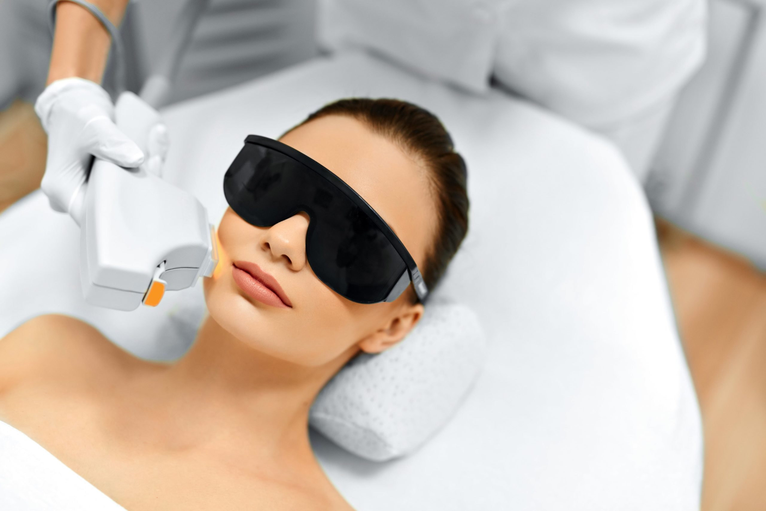 Woman Receiving Fraxel Laser Therapy by Wearing Safety Goggles | Purely Natural Medical Spa in Brooklyn, NY