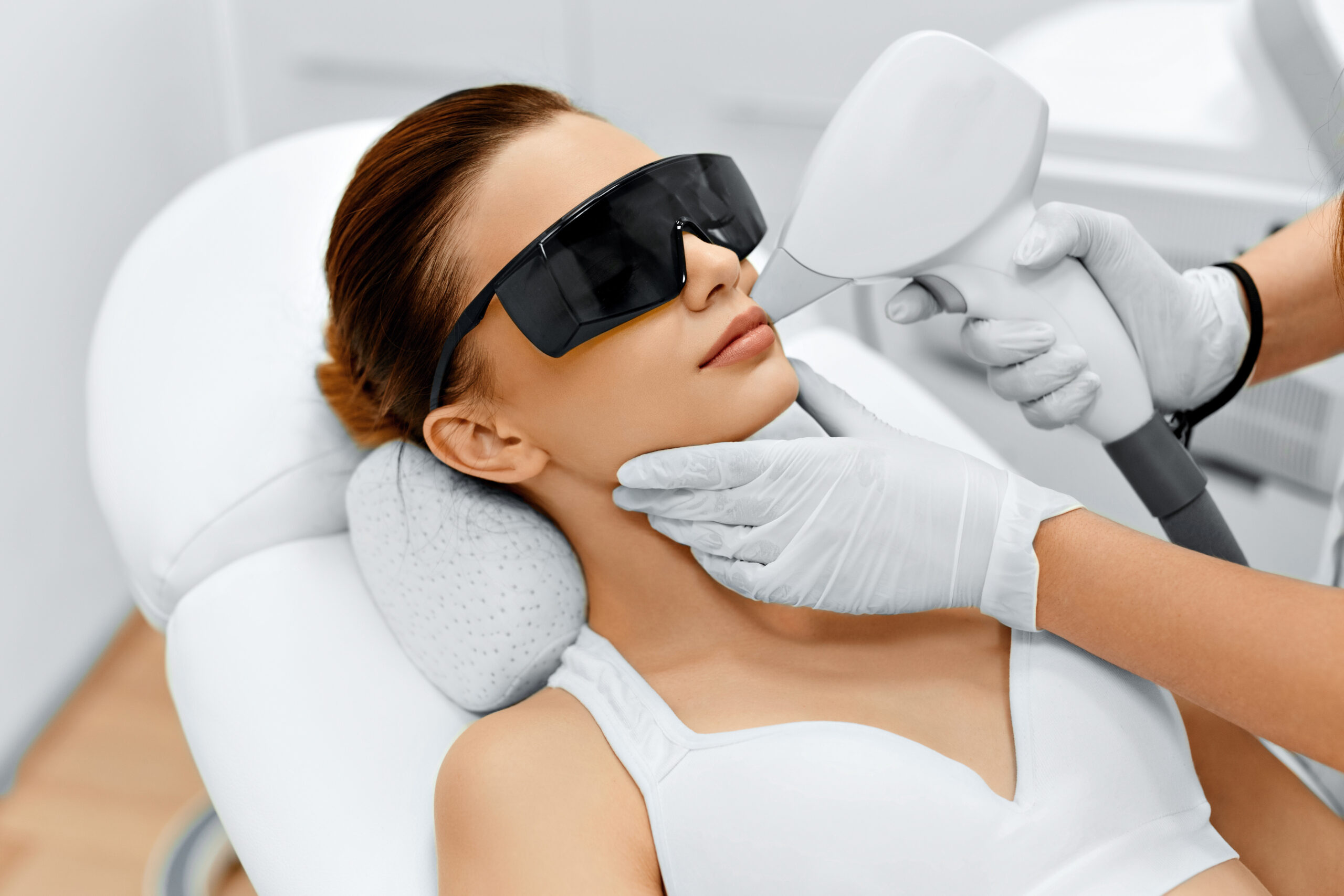 A Woman getting Laser Treatment on Skin through a Device | Purely Natural Medical Spa in Brooklyn, NY